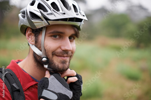 Its on tight. A young cyclist fastening his helmet. © Alexandra/peopleimages.com