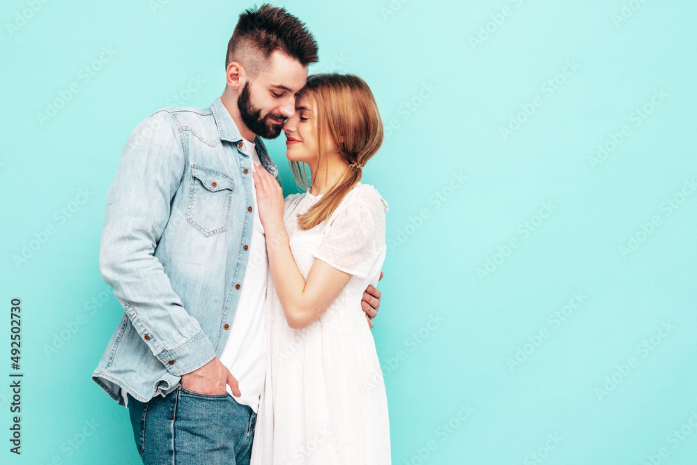 Sexy smiling beautiful woman and her handsome boyfriend. Happy cheerful family having tender moments near blue wall in studio.Pure cheerful models hugging.Embracing each other. Cheerful and happy Sexy smiling beautiful woman and her handsome boyfriend. Happy cheerful family having tender moments near blue wall in studio.Pure cheerful models hugging.Embracing each other. Cheerful and happy