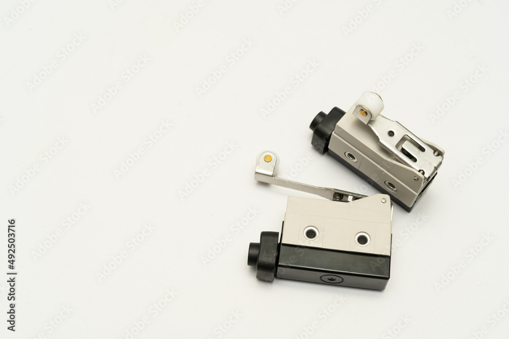 Limit switch sensor of the machine. Tiny limit switch for mechanical movement and actuators limits. isolated, white background of limit switch, control device, electrical equipment in control system. Limit switch sensor of the machine. Tiny limit switch for mechanical movement and actuators limits. isolated, white background of limit switch, control device, electrical equipment in control system.