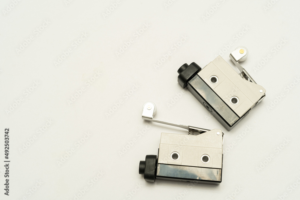 Limit switch sensor of the machine. Tiny limit switch for mechanical movement and actuators limits. isolated, white background of limit switch, control device, electrical equipment in control system.