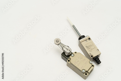 Limit switch sensor of the machine. Tiny limit switch for mechanical movement and actuators limits. isolated, white background of limit switch, control device, electrical equipment in control system.