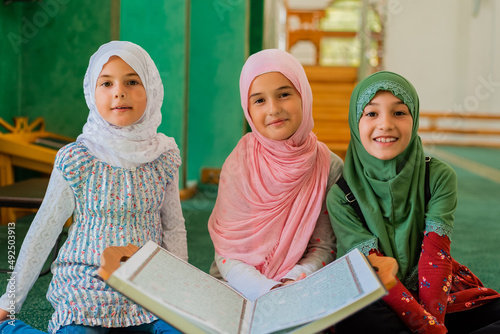 Photography Group of a children reading a holy book Quran in the mosque
