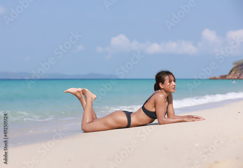 Portrait Sexy woman on the beach at island tanned woman with bikini suntan relaxing on tropical beach  summer vacation sunbathing
