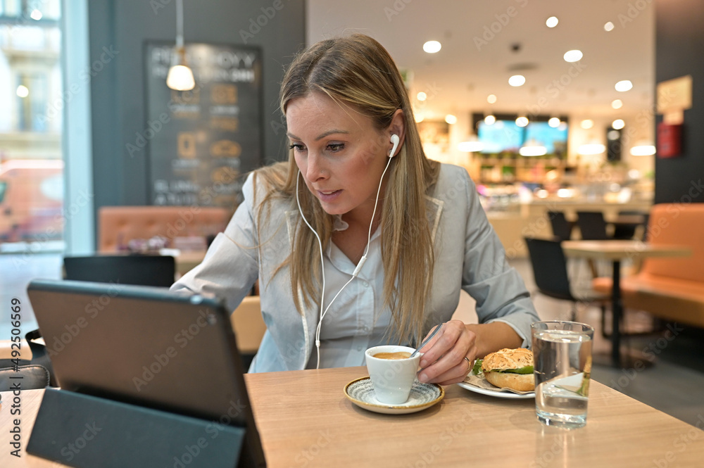 Businesswoman connected with digital tablet at lunch time Businesswoman connected with digital tablet at lunch time