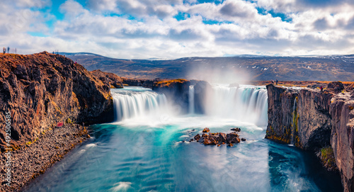 Soft waters of Godafoss - spectacular waterfall plunging over a curved, 12m-high precipice, with paths to various viewpoints. Bright summer view of Skjalfandafljot river, Iceland, Europe.