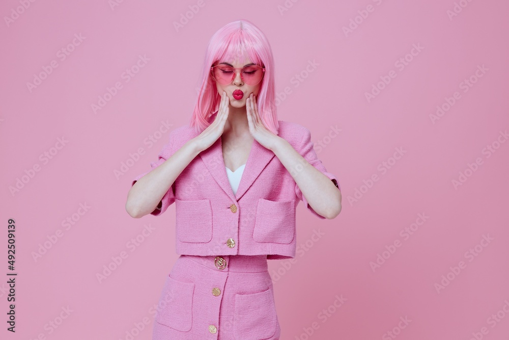 Positive young woman gestures with his hands with a pink jacket Studio Model unaltered