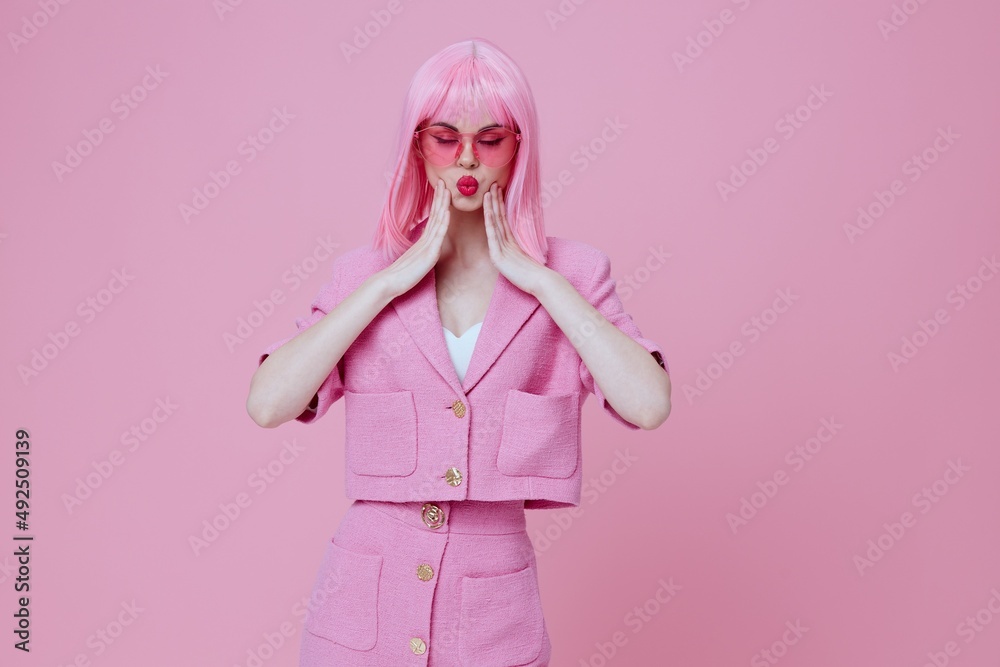 Positive young woman gestures with his hands with a pink jacket Studio Model unaltered Positive young woman gestures with his hands with a pink jacket Studio Model unaltered