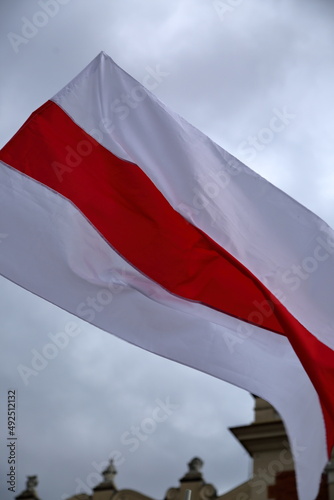 Billede på lærred Original flag of Belarus used by political opposition waves against sky