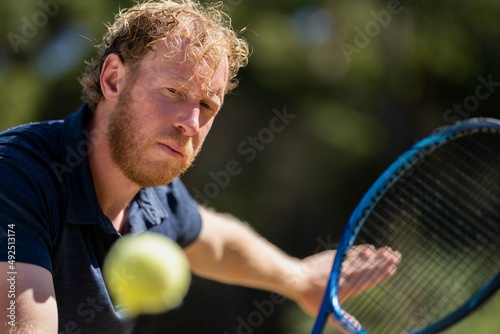 close up of Amateur reaching for a tennis ball while playing tennis in Melbourne, Australia  © William