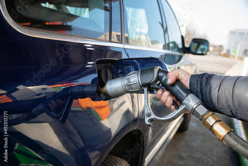 Fueling up the car at the gas station, road trip, driving, expensive, gas pump, gasoline, gas station, filling up, gas tank, getting gas, energy, power, industry, car trip, high gas prices, expensive 