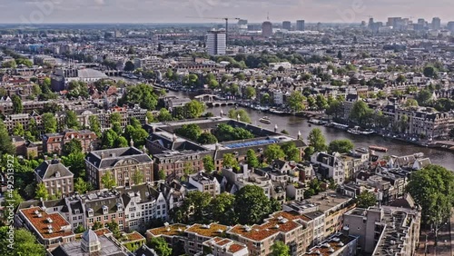 Amsterdam Netherlands Aerial v34 pan shot away from blauwbrug bridge towards weesperstraat street capturing hermitage museum and historic downtown cityscape across the neighborhoods - August 2021 photo