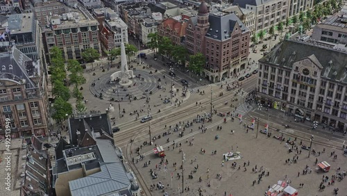 Amsterdam Netherlands Aerial v13 birds eye view from above royal palace overlooking at crowded dam square, national monument and surrounded dutch architectures at binnenstad neighborhood - August 2021