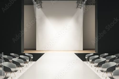 Modern concrete auditorium interior with seats, runway and empty mock up place on wall. Presentation and fashion concept. 3D Rendering.