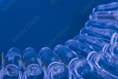 Glass medical ampoule vial for injection. Medicine is liquid sodium chloride with of aqueous solution in ampulla. Close up. Bottles ampule multicolor on background color and water. Human plasma.