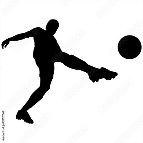 Black silhouette of a soccer player making a jump shot at the ball.