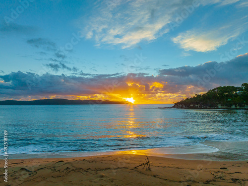 Aerial sunrise at the seaside with clouds, woman and child