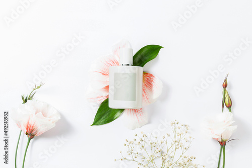 flowers and bottle on a white background