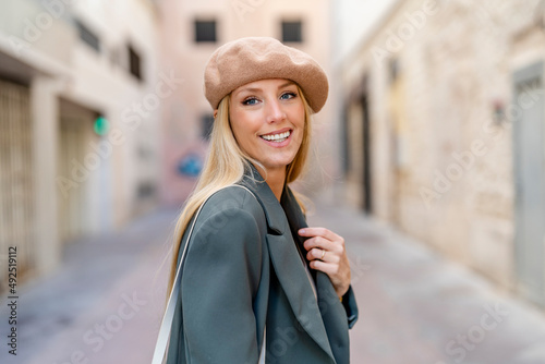 Smiling beautiful woman with long blond hair wearing beret