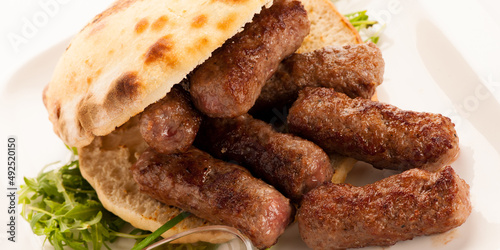 photo of Cevapi, cevapcici, traditional  Balkan food - delicius minced meat - banner size photo