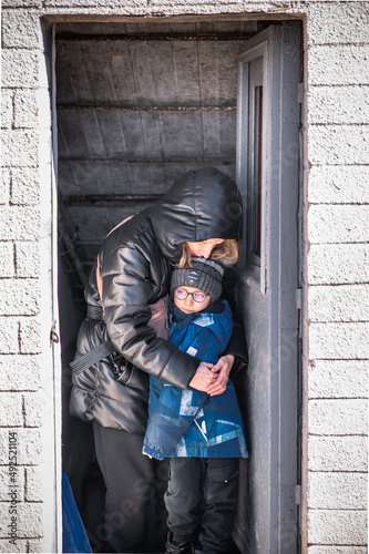 Mom with boys in a bomb shelter. Ukraine war with Russia. People are hiding in basements.