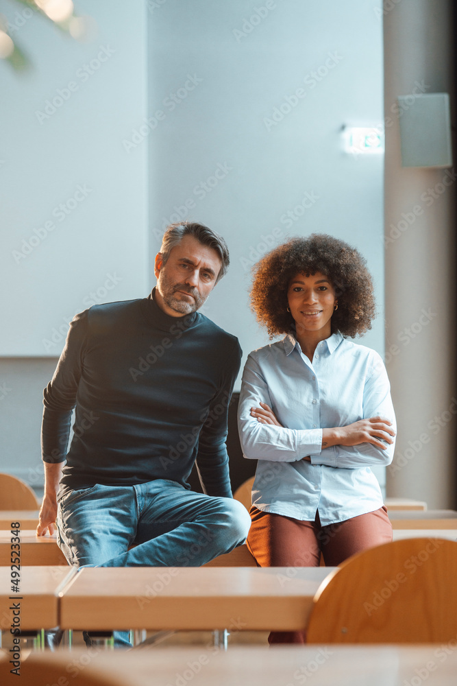 Working woman with arms crossed by colleague at work place Working woman with arms crossed by colleague at work place