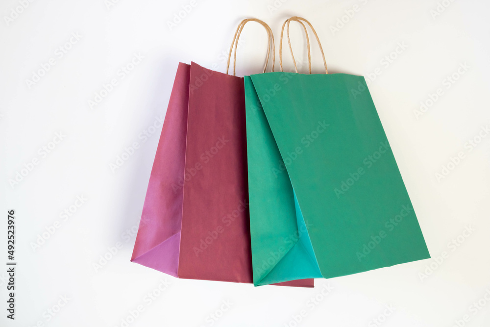Ecology concept Colored paper shopping Bags Isolated on a white background