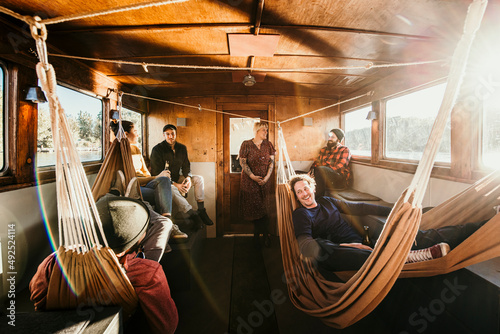 Happy friends enjoying leisure time together on boat on sunny day photo