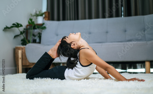 girl doing yoga in room on white carpet