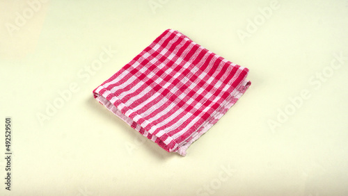 Folded kitchen textile towels of different colors, Household cleaning cloth. Closeup of cleaning rag isolated on a white background. 