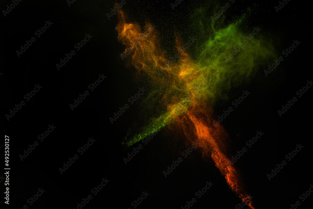 Fototapeta premium Freeze motion of colorful dust explosion on black background for Happy Holi