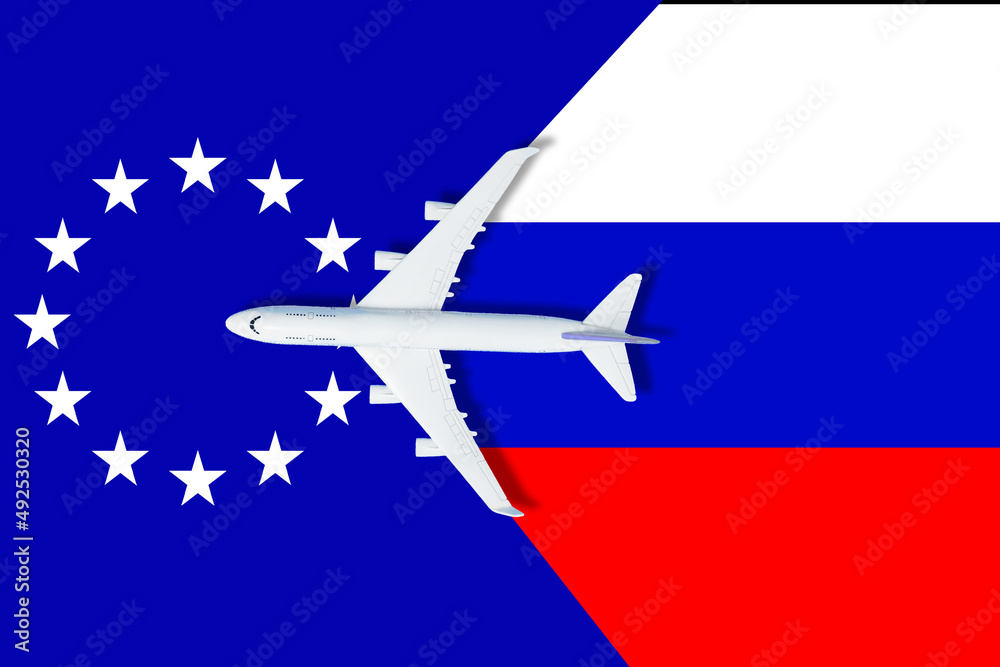 Fototapeta premium no travel by plane closed sky because of war conflict between Russian and Ukraine toy plane with russian flag