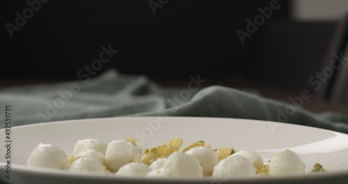 mozzarella balls on penne in white bowl