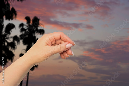 Hot summer mock up. Travel and adventure themes. Woman hand on Malibu landscape