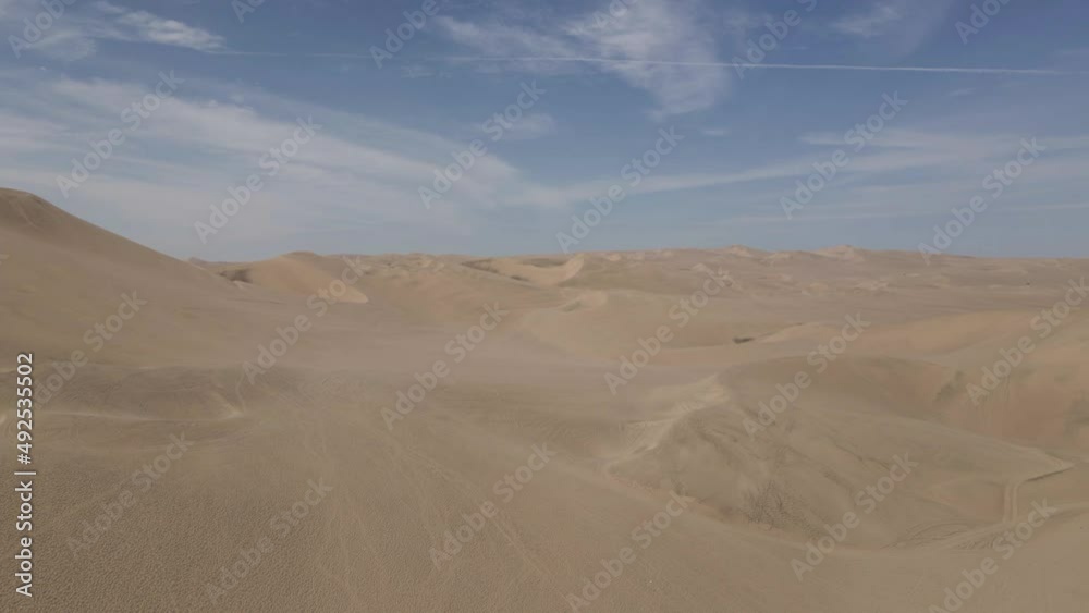 Aerial rises over huge wind sculpted sand dunes in Peruvian desert Aerial rises over huge wind sculpted sand dunes in Peruvian desert