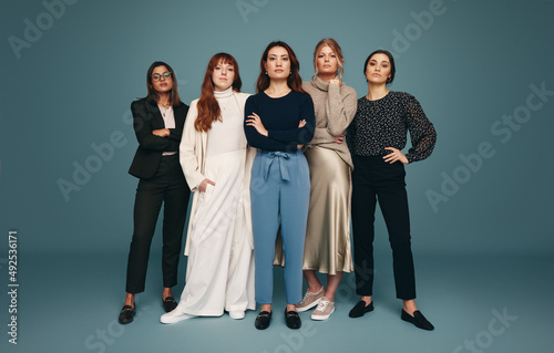 Five empowered women standing together in a studio photo