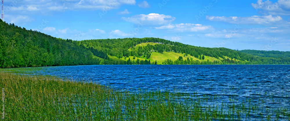 Fototapeta premium nature park with lake and hills wide panoramic shot