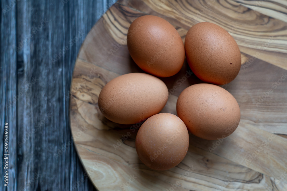 Eggs on a wooden plate, rustic background Eggs on a wooden plate, rustic background