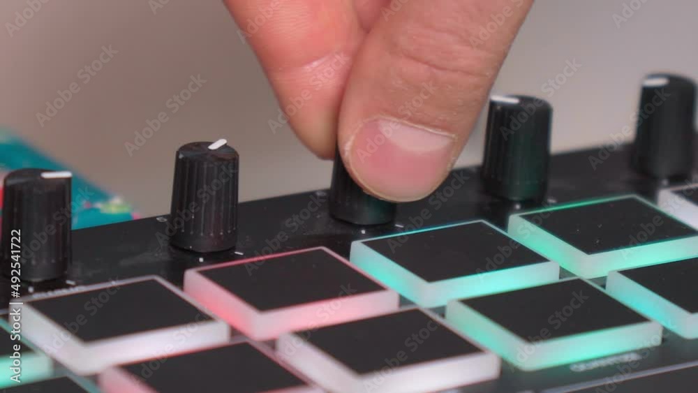 Details of modern midi keyboard in small home studio. Midi keyboard with keys and pads