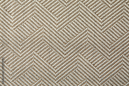 Knitted texture. Texture of jacquard fabric with gray geometric pattern. Crochet mosaic pattern.