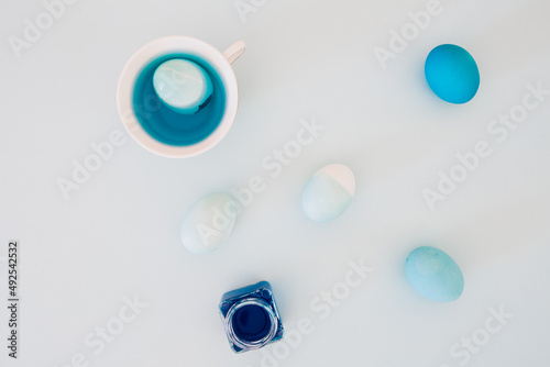 Top view of colorful easter eggs on white background