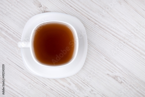 Black tea in a white cup, close-up.
