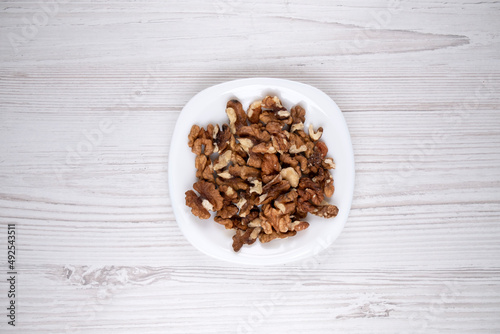 Walnuts on a white plate. A plate of nuts on the table. Healthy food. Man's health.