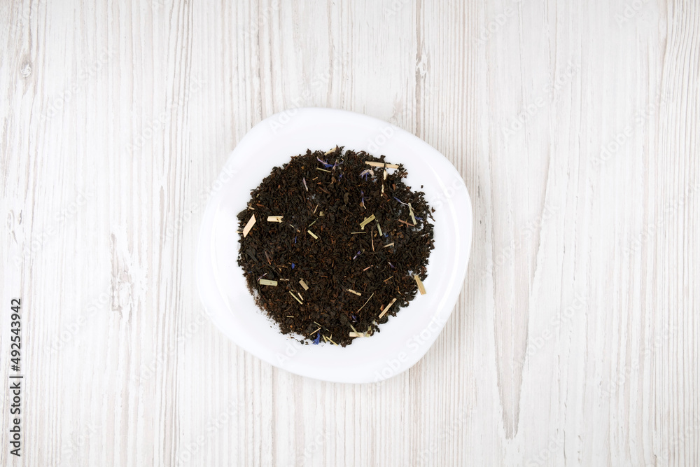 Tea brew on a white plate, top view. Black tea with additives Tea brew on a white plate, top view. Black tea with additives