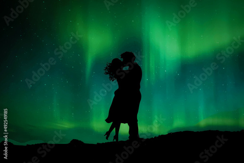 couple silhouettes kissing on background northern lights use for news advertisement flyer poster