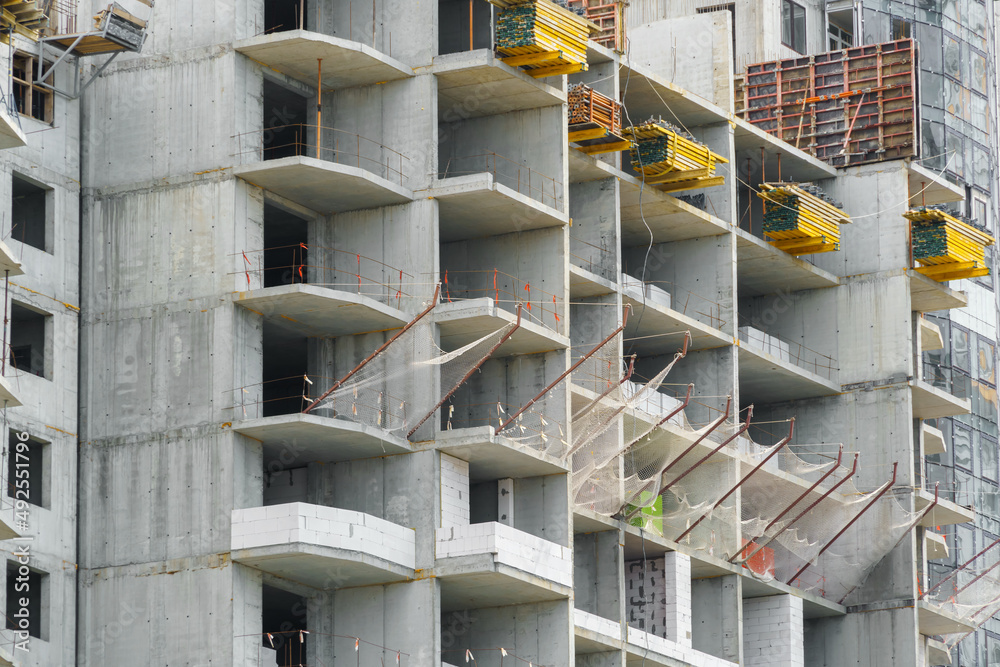construction of a modern high-rise building, the creation of a concrete frame, building materials and a construction crane construction of a modern high-rise building, the creation of a concrete frame, building materials and a construction crane