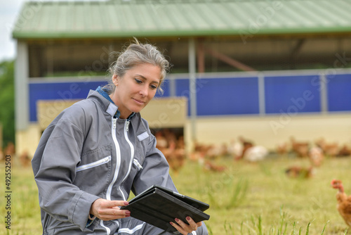 Breeder woman in field with hern in background photo