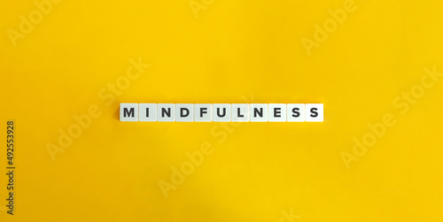 Mindfulness Word on Letter Tiles on Yellow Background. Minimal Aesthetics.