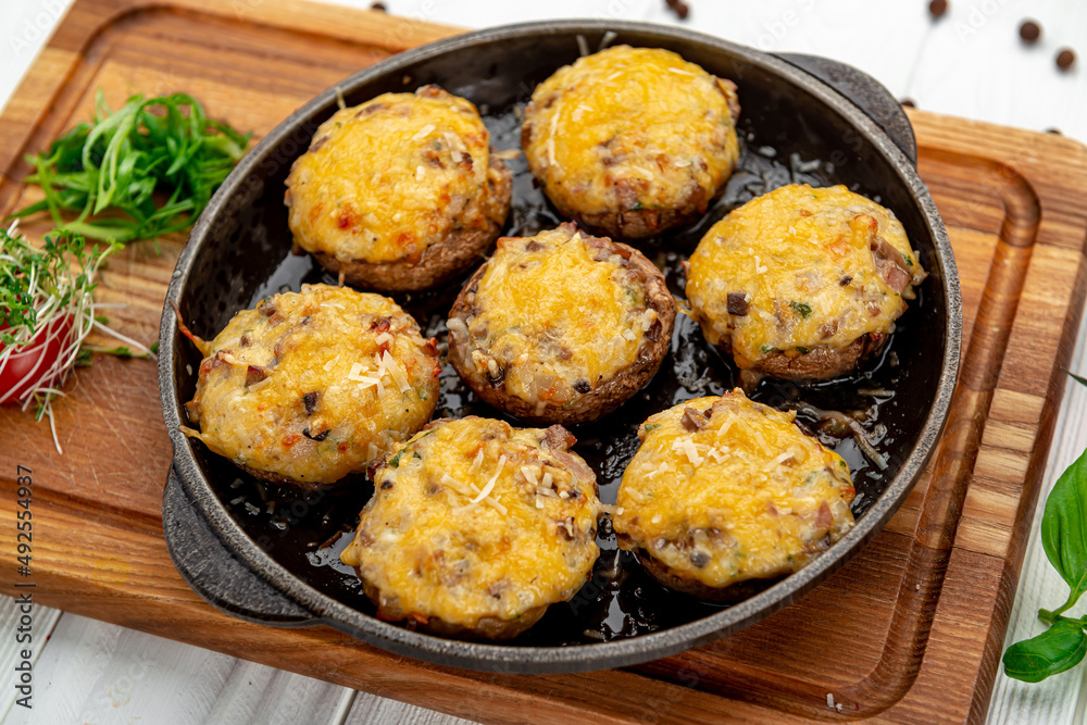Stuffed champignons baked with cheese. Stuffed champignons baked with cheese.
