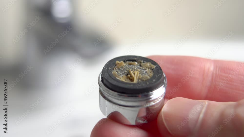Сlogged dirty faucet aerator with corrosive calcium plaque in plumber