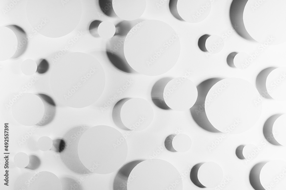 White paper circles as energy abstract pattern in shining hard light with soft shadows, reflection, glare, top view. Simple bright modern background in future minimalistic style. White paper circles as energy abstract pattern in shining hard light with soft shadows, reflection, glare, top view. Simple bright modern background in future minimalistic style.